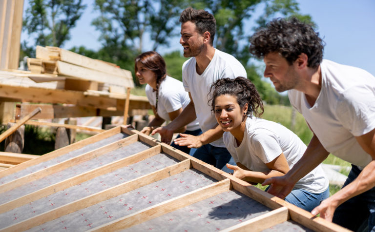 Argentina: Latin american volunteers working hard at a charity construction project - Charity and relief concepts