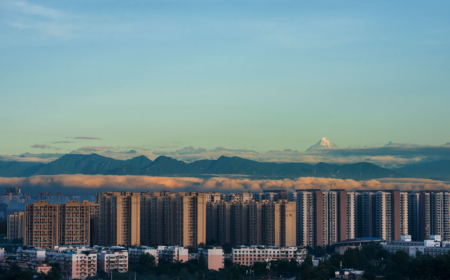 City view with snow capped mountains
