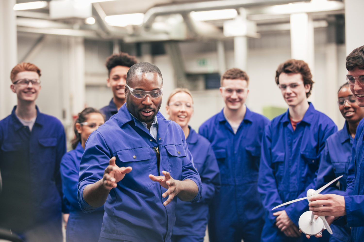 Un tuteur enseigne à sa classe les énergies renouvelables dans un atelier d'ingénierie.