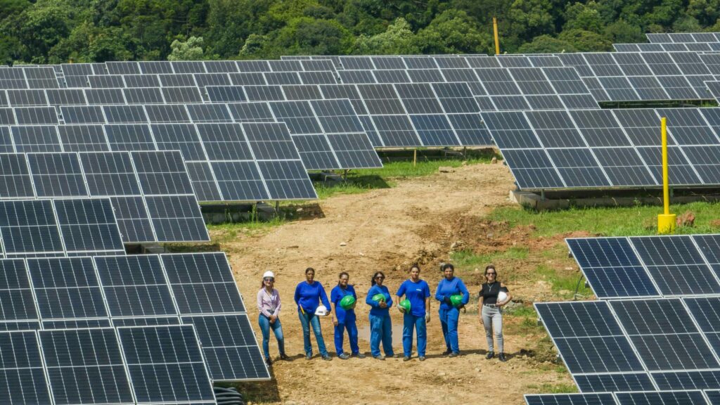 Solar workers pose for a photo in a solar plant in Curitiba