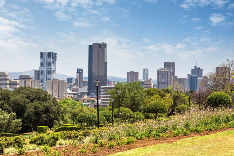 Photo overlooks the city of Tshwane, with natural greenscape in front.